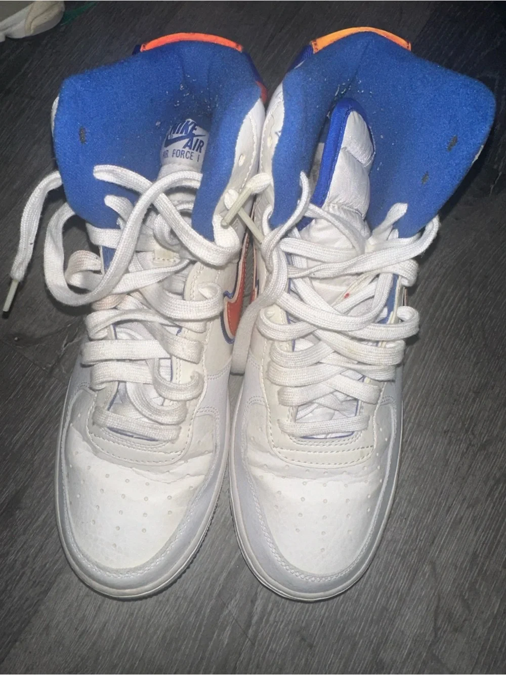 Nike White High-Top Sneakers with Orange Swoosh and Blue Accents